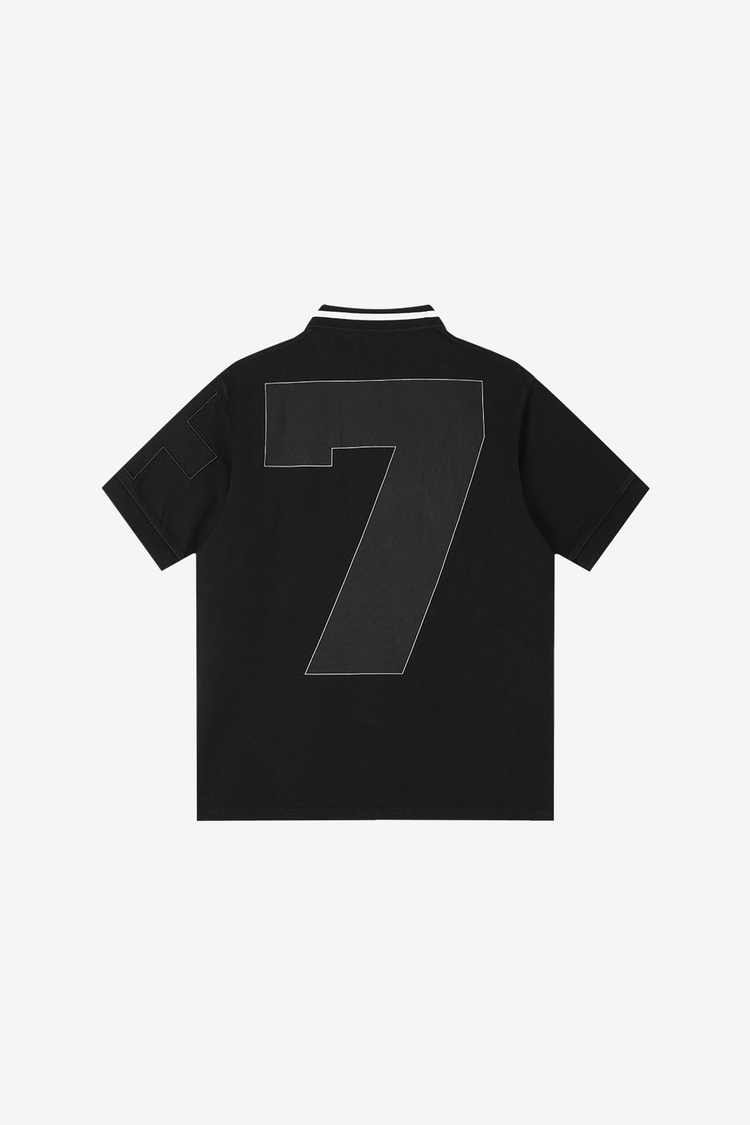Back of the black E.M.O Polo laid flat, with large stitched number 7