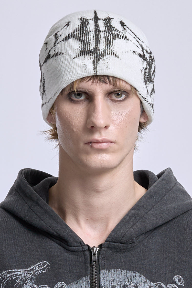 Model wearing the White Glitch Logo Beanie with black glitch logo, front close-up