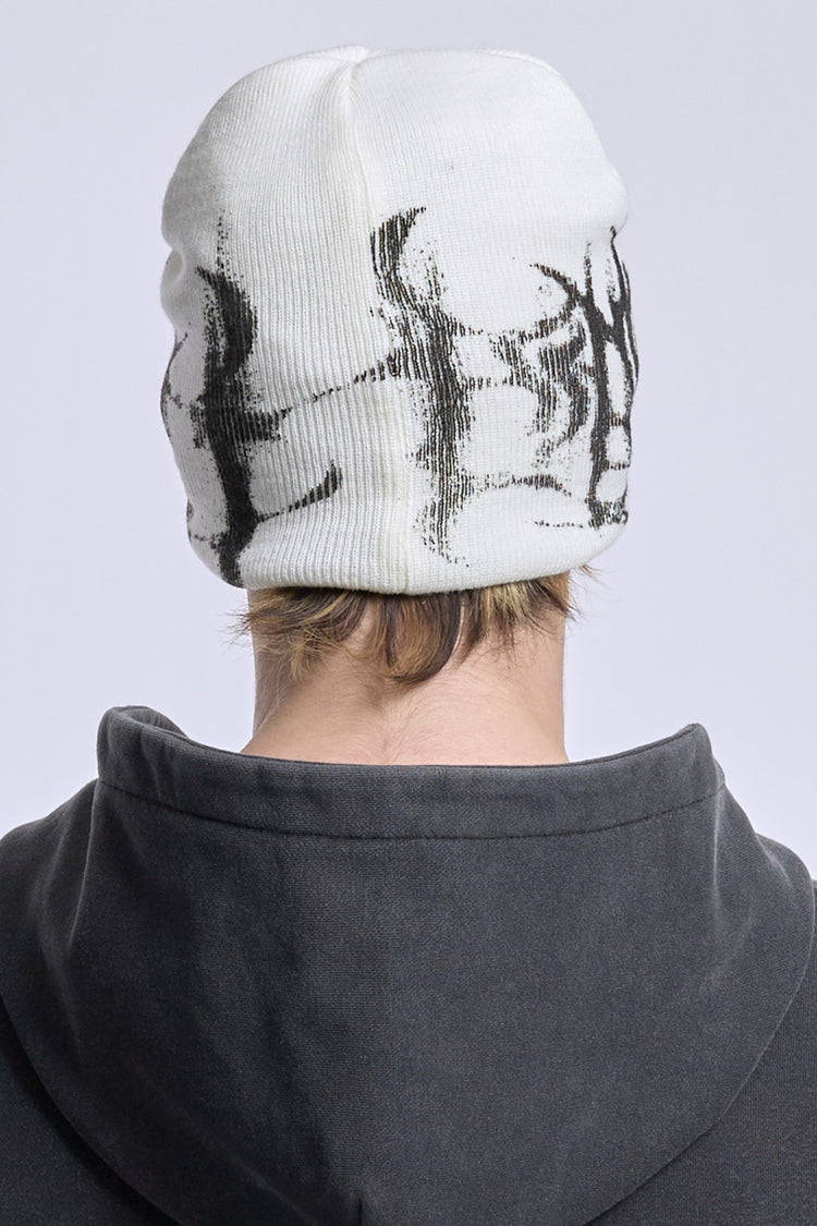 Back view of the White Glitch Logo Beanie on model, black glitch knit around the cuff