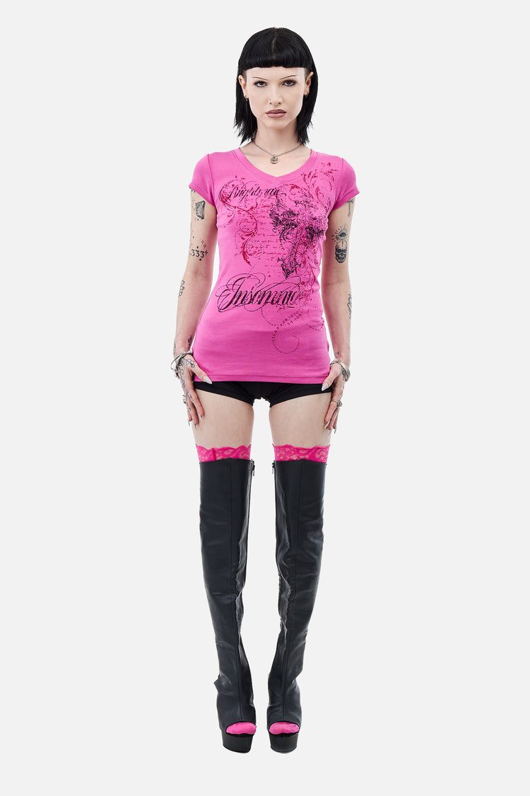 Full-length front view of the Lovers V-Neck T-Shirt in pink styled with thigh-high boots