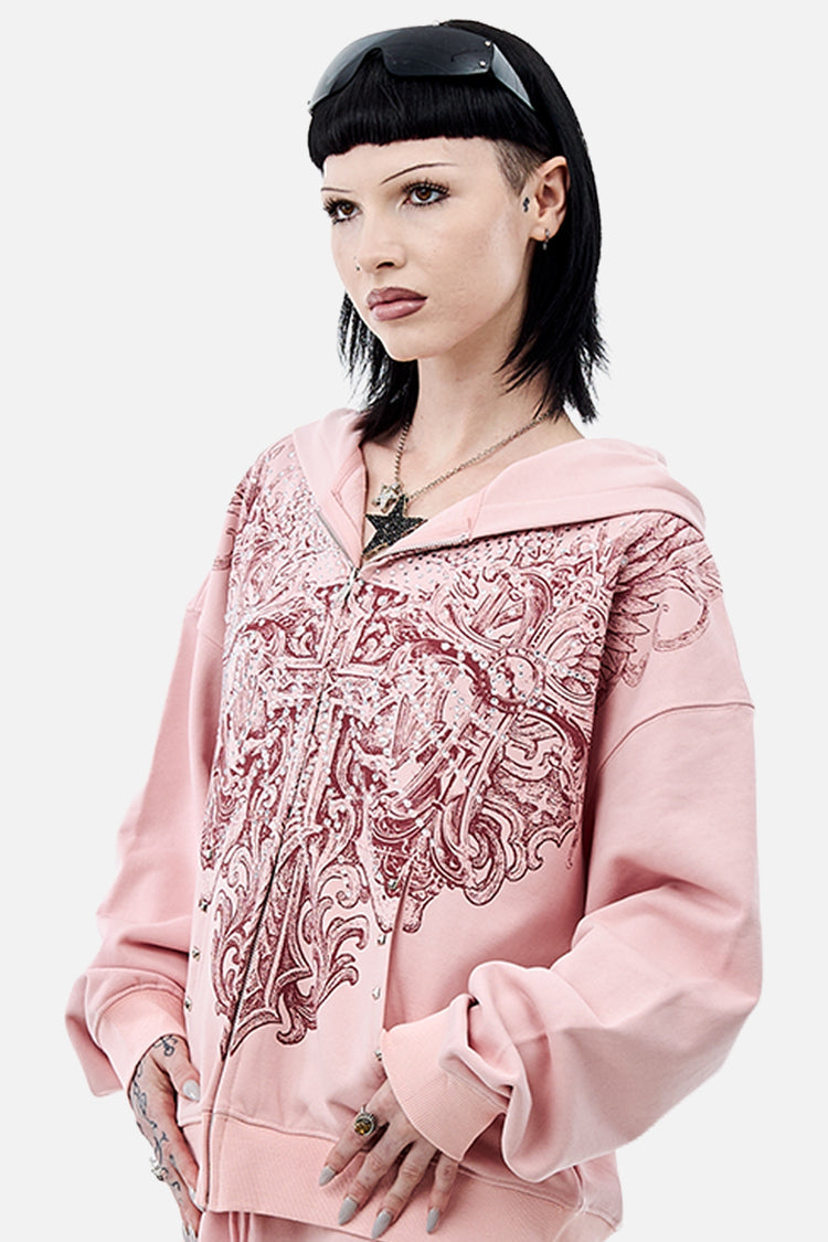 Three-quarter view of model in the pink Bonnie Hoodie with ornate burgundy print