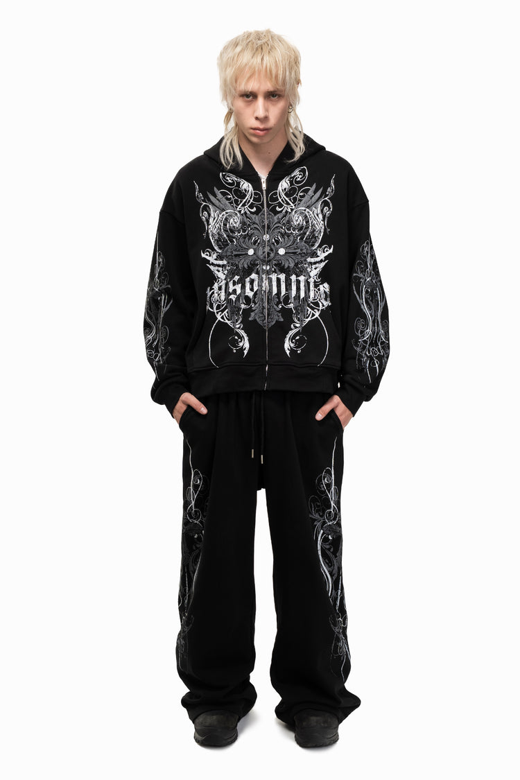Model wearing the Black Crux Sweatpants with the matching Crux zip hoodie, full-length front view