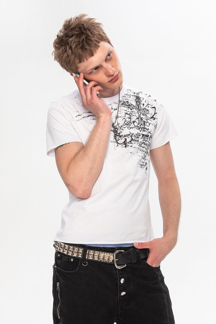 Model on a phone wearing the Orison Tee with a studded belt and black jeans