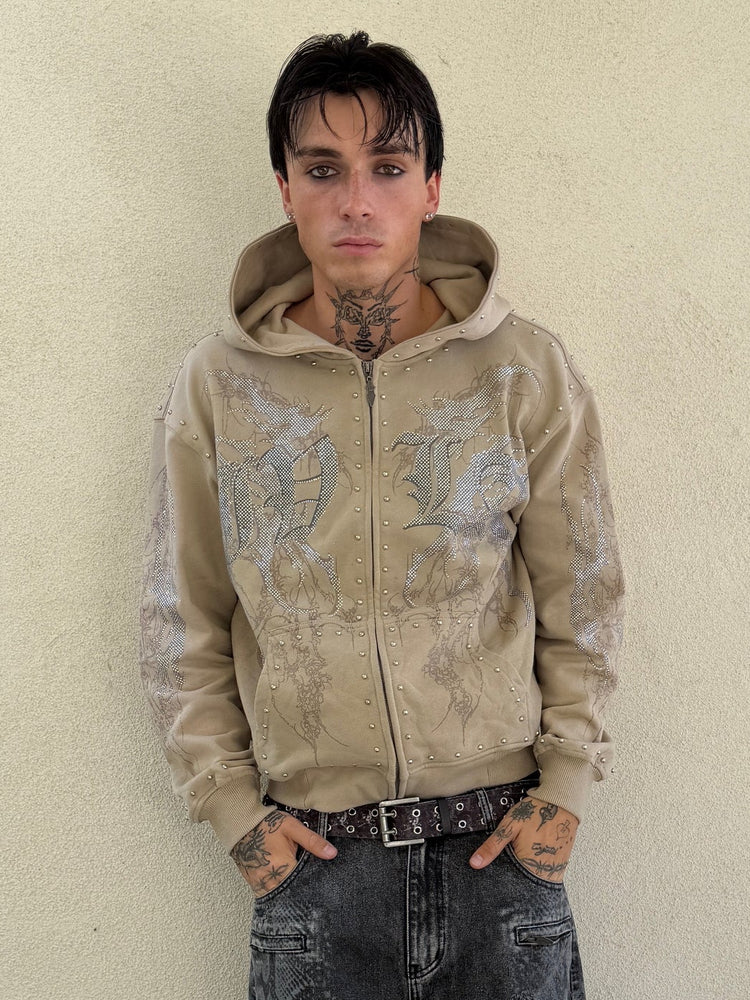 Front view of the IVLA Zip Up Hoodie on a tattooed model against a cream wall