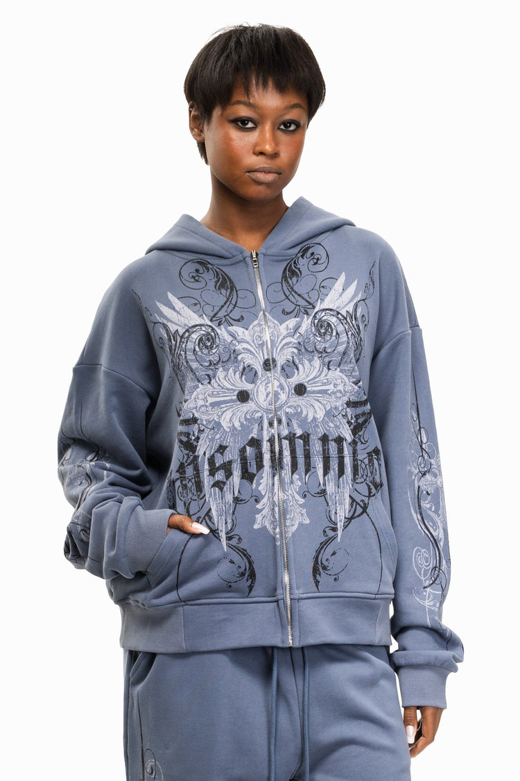 Close-up of a model in the Midnight Blue Crux Hoodie with hand in the front pocket