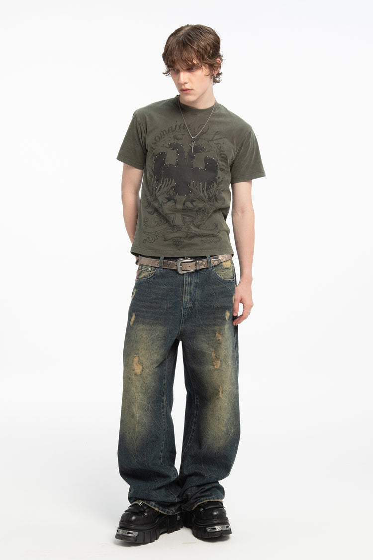 Model wearing the Sand Outlaw Denim with an olive graphic tee, full-length front view