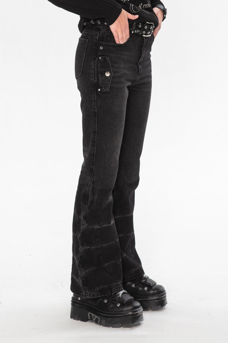 Side view of the Thorns Flared Denim with studded belt and black platform boots