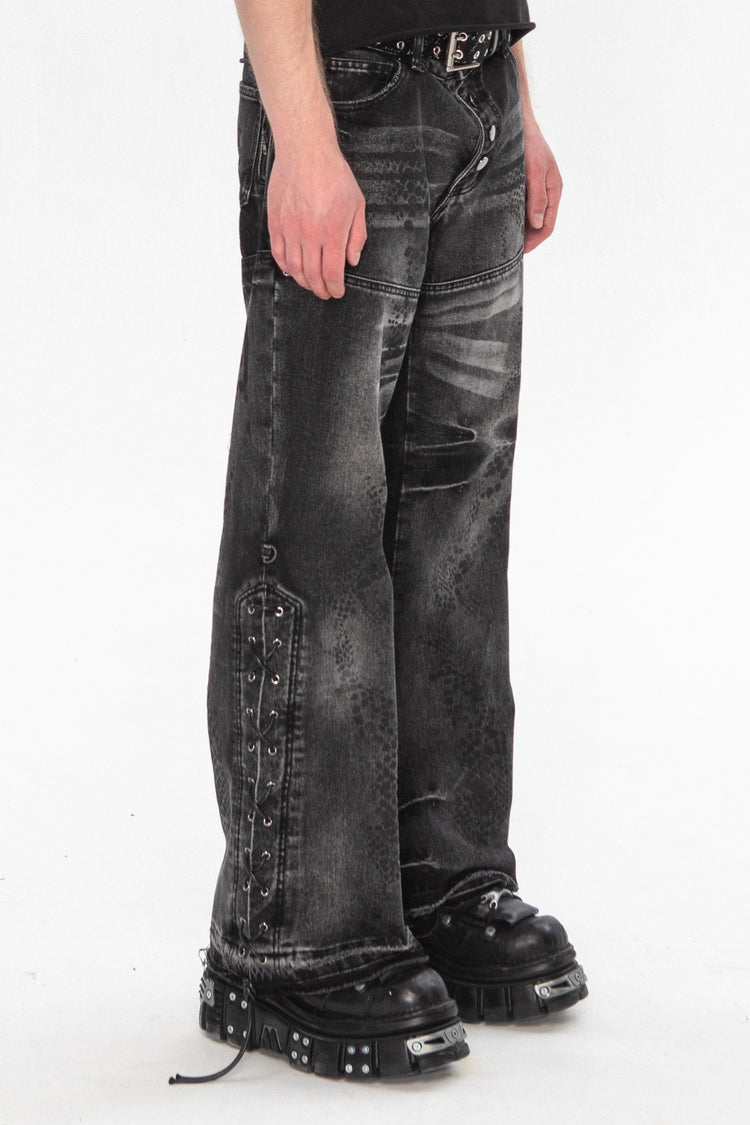 Side view of the Snakeskin Flared Denim showing the laced outseam and raw hems