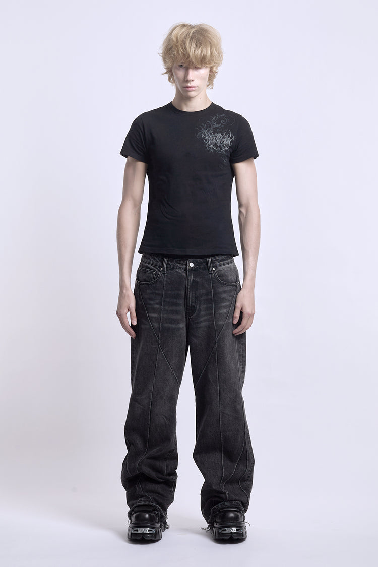 Model wearing the baggy black Vex Denim with a fitted black tee, full-length front view