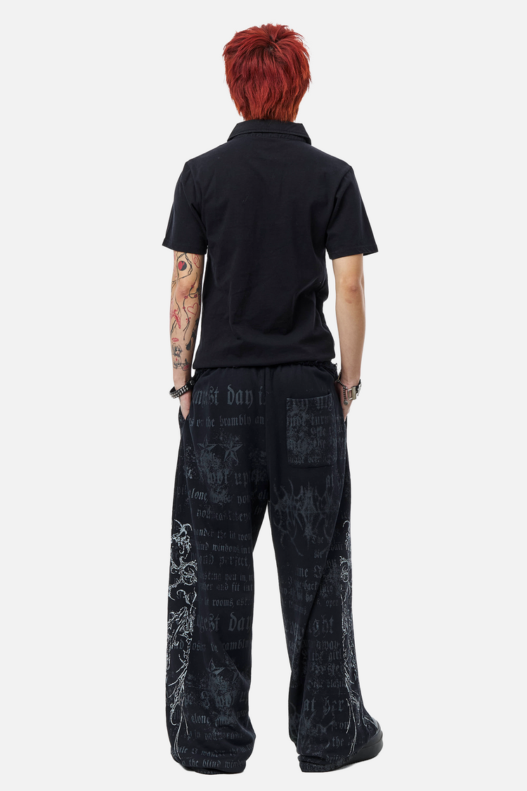 Model in the Sacred Sweatpants and black polo, full-length back view