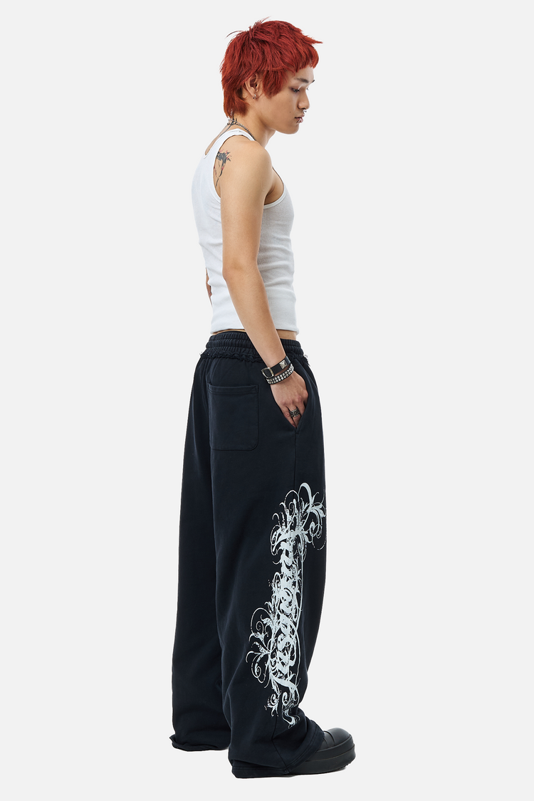 Full-length side view of the black Eternal Sweatpants styled with a white tank