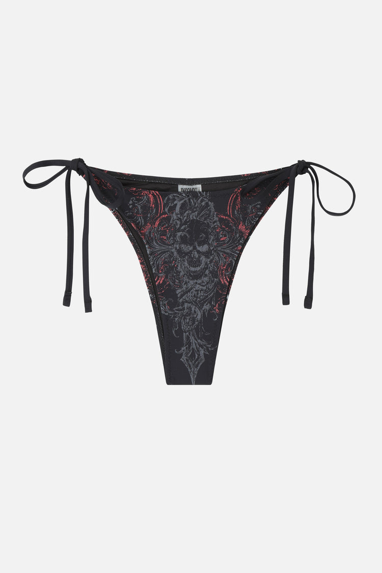 Crux Bikini Bottom on its own, black tie-side bottom with skull and filigree print