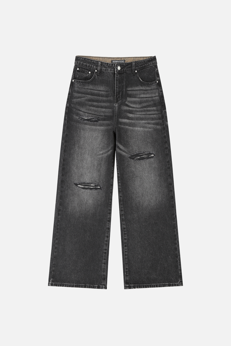 Front of the faded black Plaid Patch Outlaw Denim laid flat, with slashed knee rips