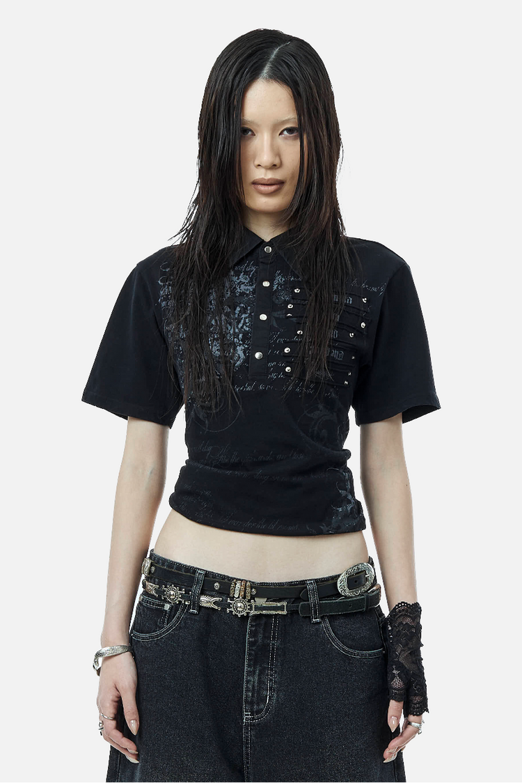 Model wearing the Black Thorns Polo cropped with low-rise baggy jeans and a studded belt