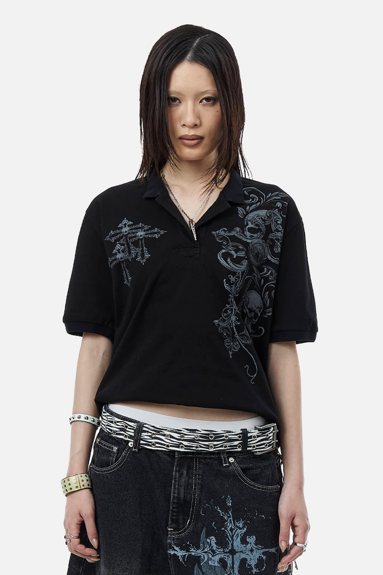 Model wearing the Skull Garden Polo cropped, with a zebra belt and printed black jeans