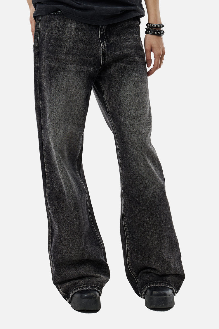 Front view of the Washed Black Outlaw Denim with a black tee and beaded bracelets