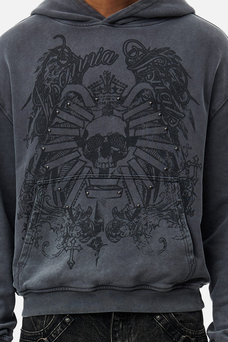 Close-up of the Crest Hoodie front showing studded skull and wings print