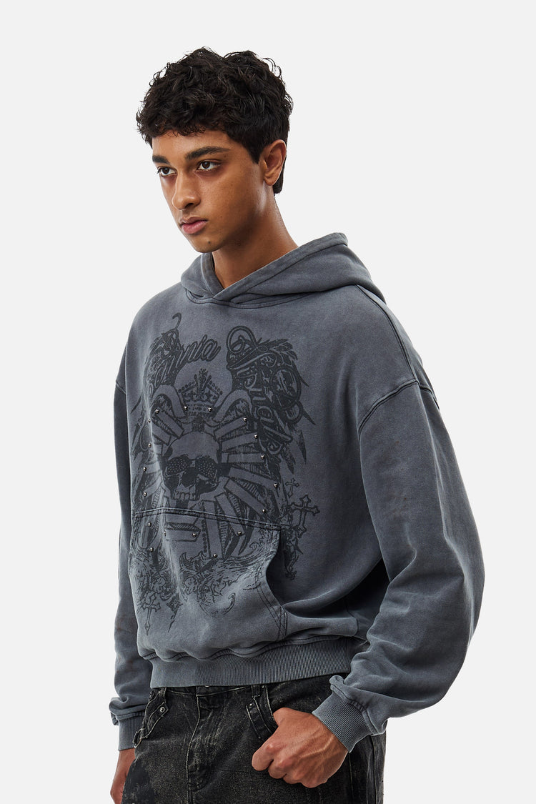 Three-quarter view of the Crest Hoodie in faded charcoal with tonal skull graphic