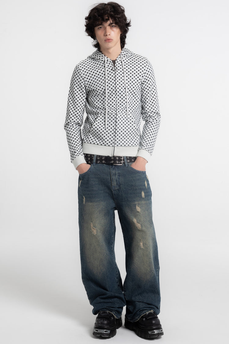 Model wearing the Polka Dot Slim Zip Hoodie with baggy faded jeans, full-length front view