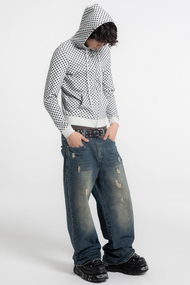 Model in the Polka Dot Slim Zip Hoodie with hood up and hands in jean pockets