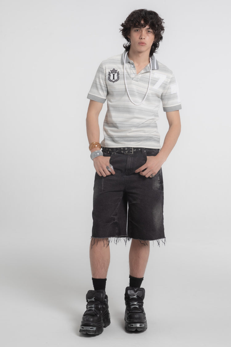 Full-length front view of the Striped Crest Polo with black cutoff shorts and platform boots