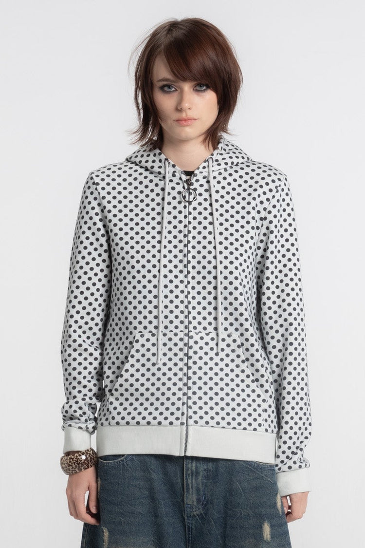 Waist-up front view of the white Polka Dot Slim Zip Hoodie with black dots, zipped