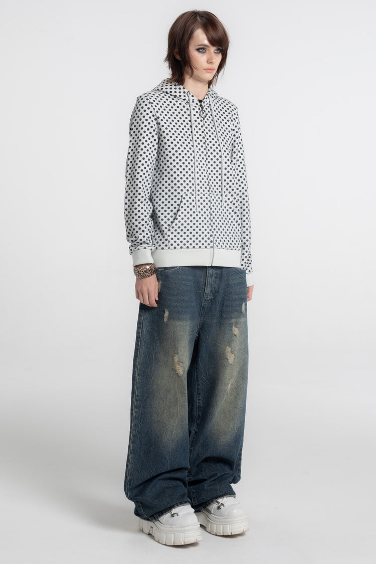 Model in the Polka Dot Slim Zip Hoodie with baggy jeans and white sneakers, full length