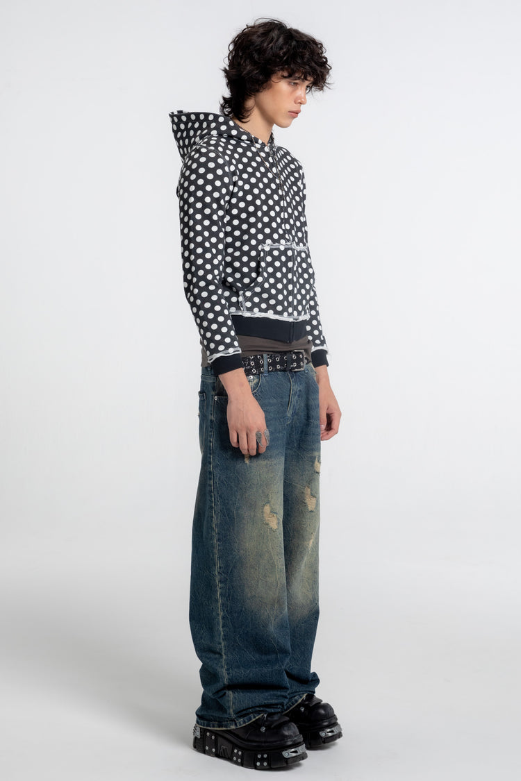 Side view of the Black Polka Dot Slim Zip Hoodie worn with wide distressed jeans and chunky boots