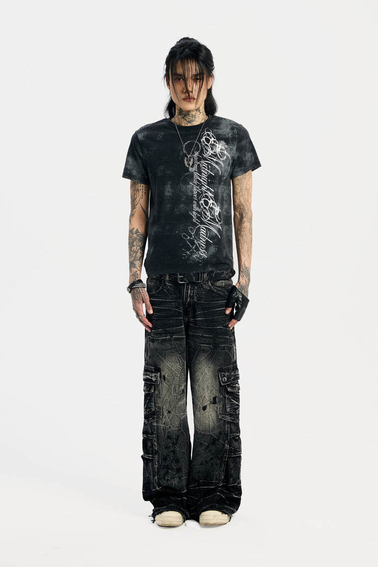 Model in the Midnight Tee with distressed black cargo jeans, full-length front view