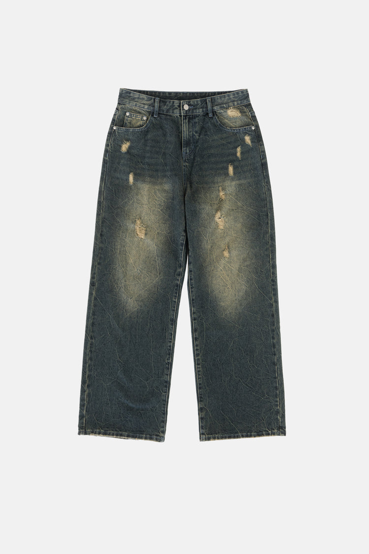 Front of the Sand Outlaw Denim laid flat, showing sandy faded wash and distressing