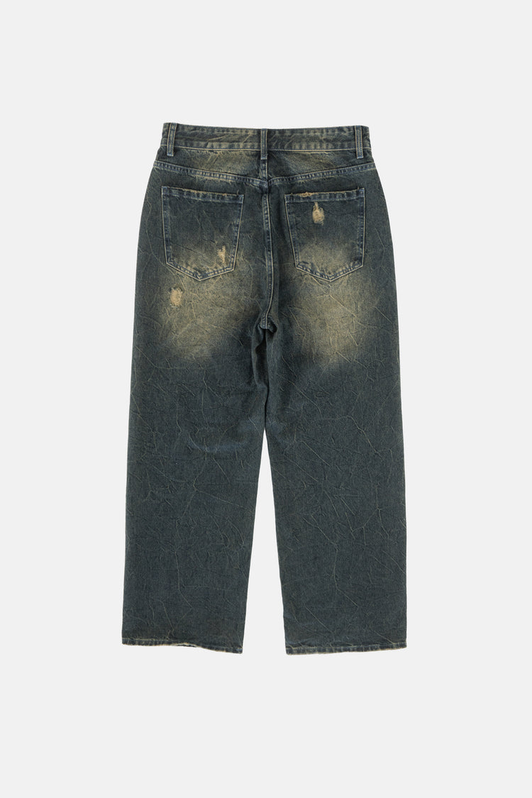Back of the Sand Outlaw Denim laid flat with faded seat and worn pocket details