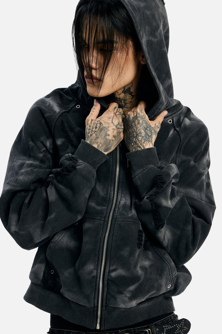 Close-up of a model pulling the hood of the Studded Raglan Zip Up Hoodie