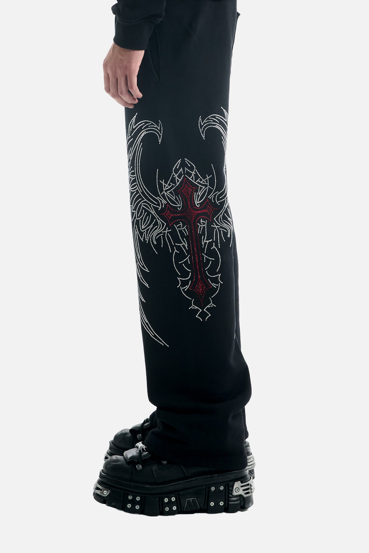 Close side view of the Red Cross Baggy Sweats leg graphic, red cross with silver wings