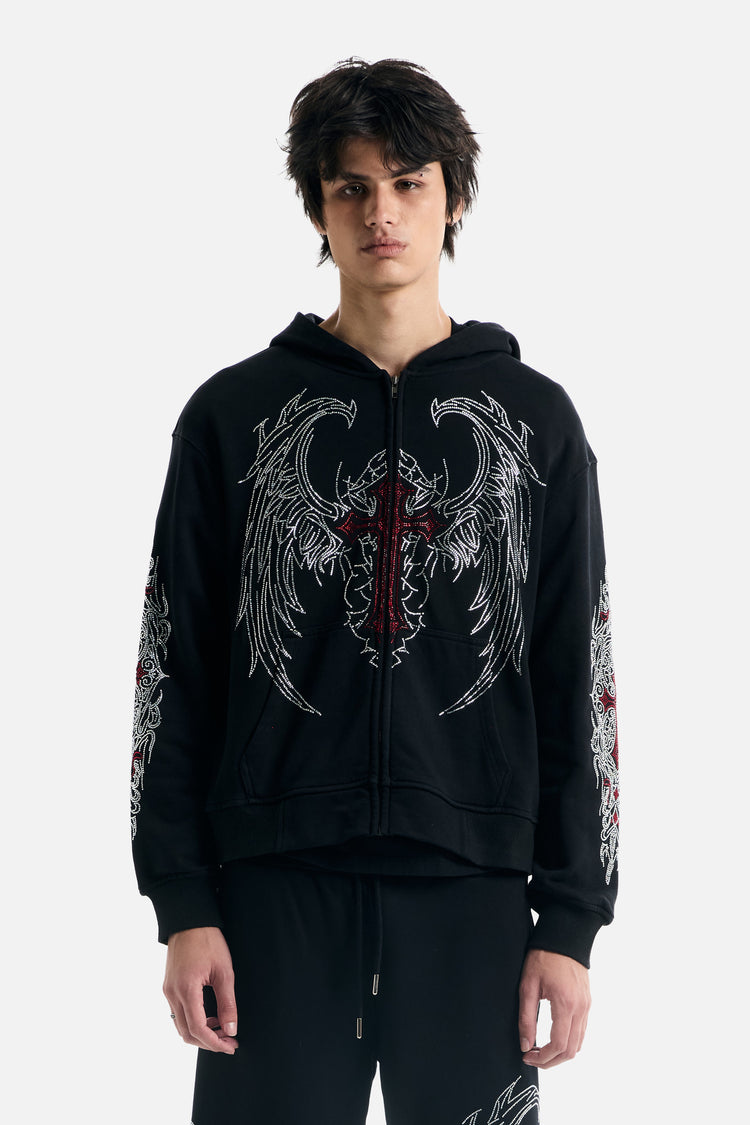 Model wearing the black Red Cross Zip Up Hoodie with rhinestone wings and red cross