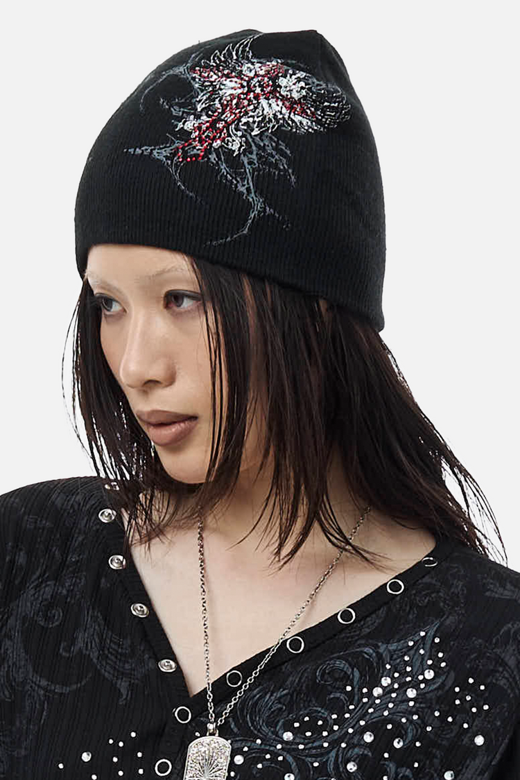 Black Blessed Beanie worn with long dark hair, three-quarter view of the cross print