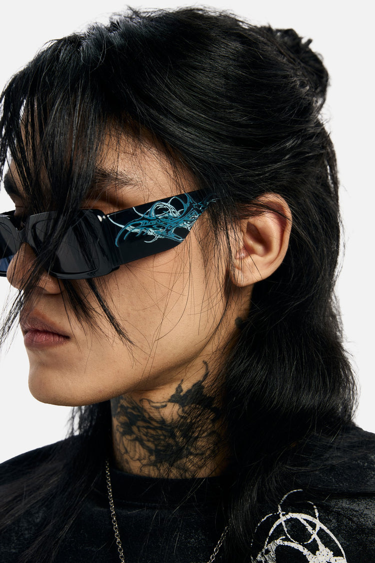 Profile close-up of the Thorns Metal Sunglasses showing the blue thorn temple