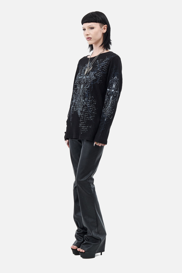 Full-length side view of the Scripture Ribbed Long Sleeve styled with leather flared pants