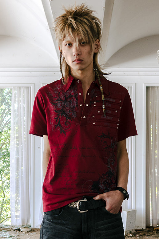 Model with spiky blonde hair wearing the red Thorns Polo in a sunlit room