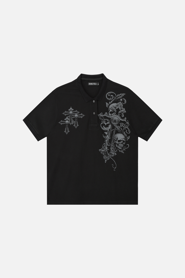 Front of the black Skull Garden Polo laid flat, showing the skull, scroll and cross graphics