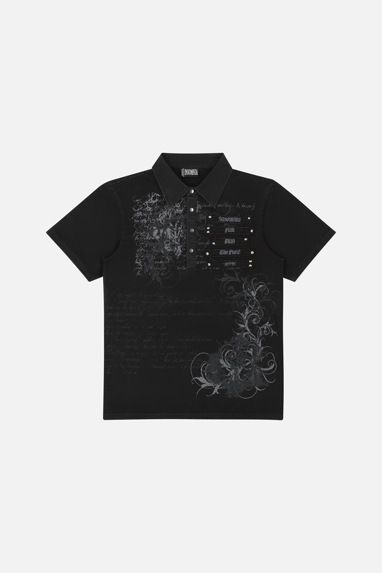Black Thorns Polo laid flat, showing grey script and thorn print with studded chest detail