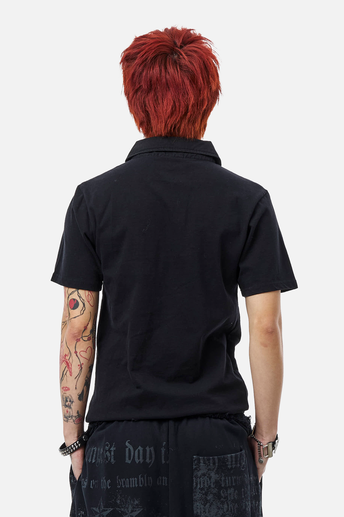 Back view of the Black Thorns Polo, plain black with short sleeves and collar