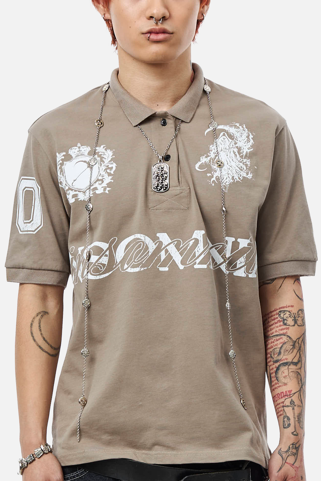 Close front view of the Reaper Polo showing silver crest and reaper graphics with chain detail