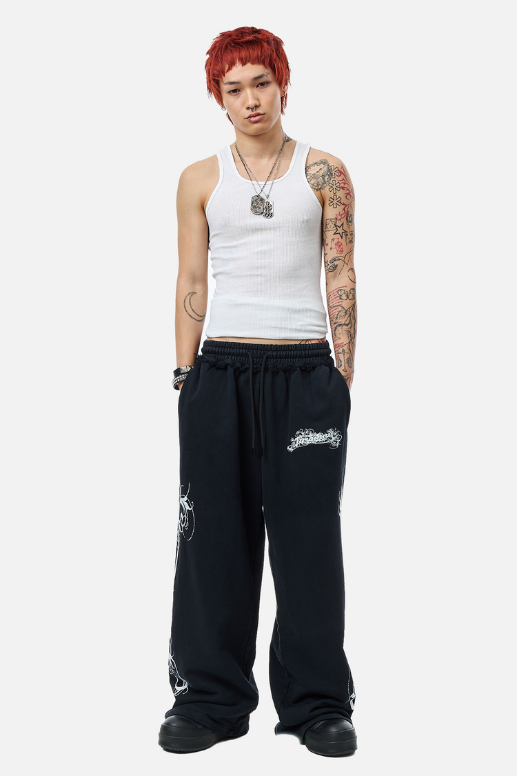 Model wearing the Eternal Sweatpants with a white ribbed tank, full-length front view