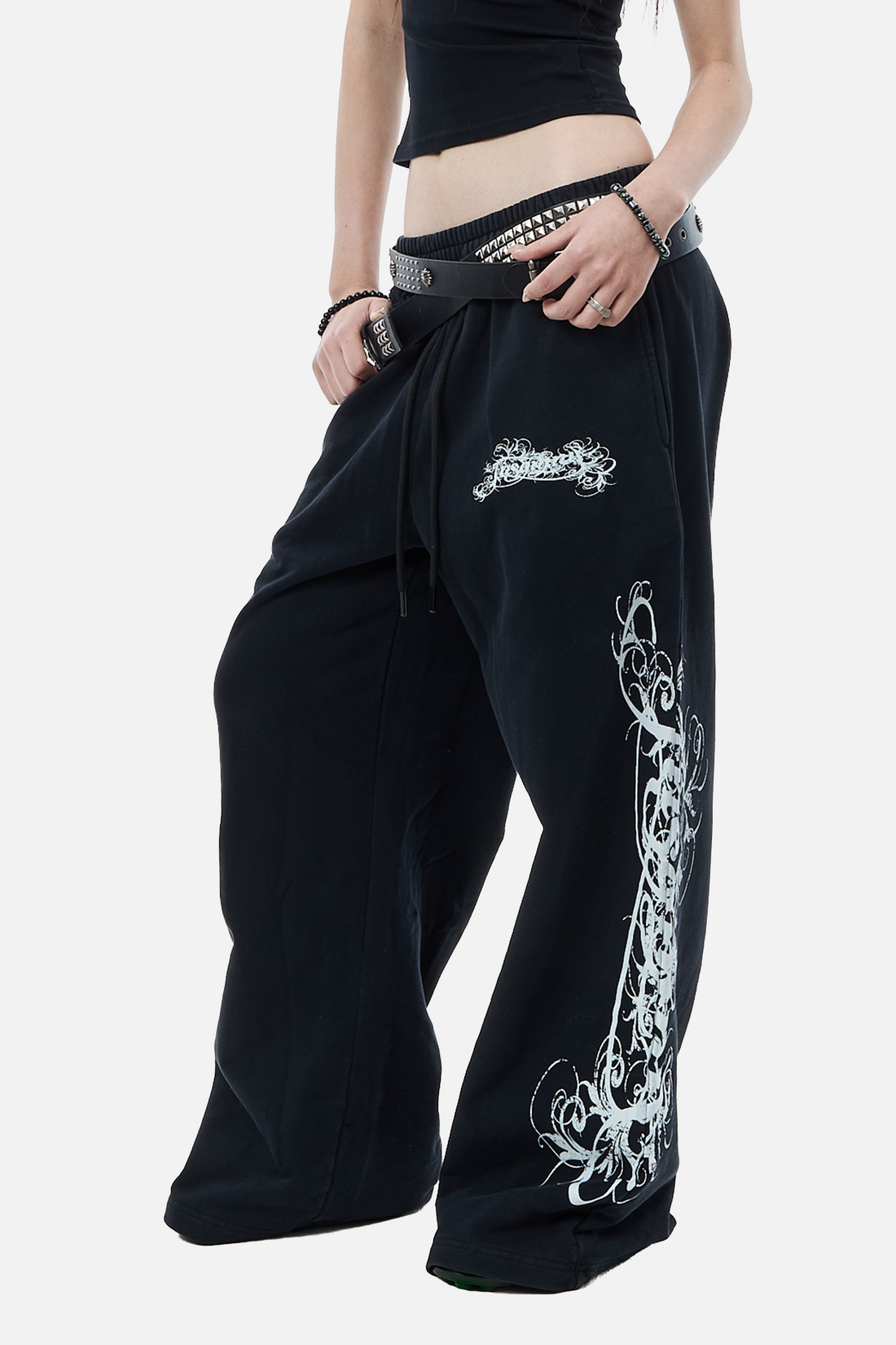 Close-up of the Eternal Sweatpants front with embroidered logo patch and white leg print