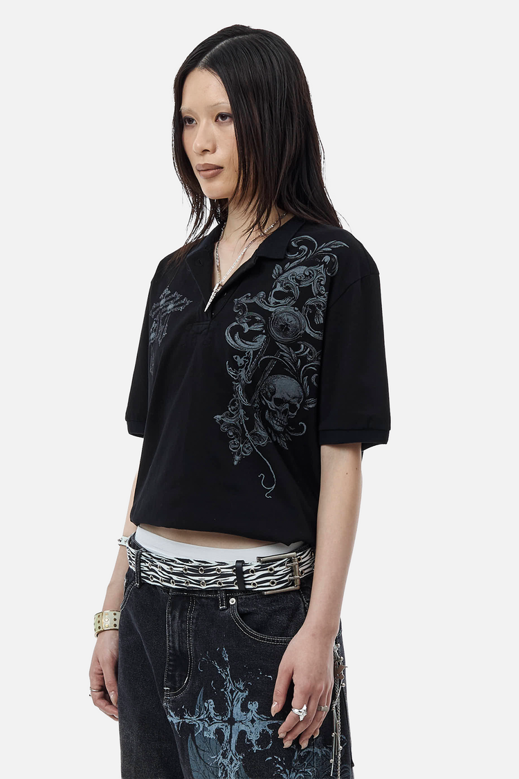 Side view of the Skull Garden Polo on a model with long black hair and printed jeans