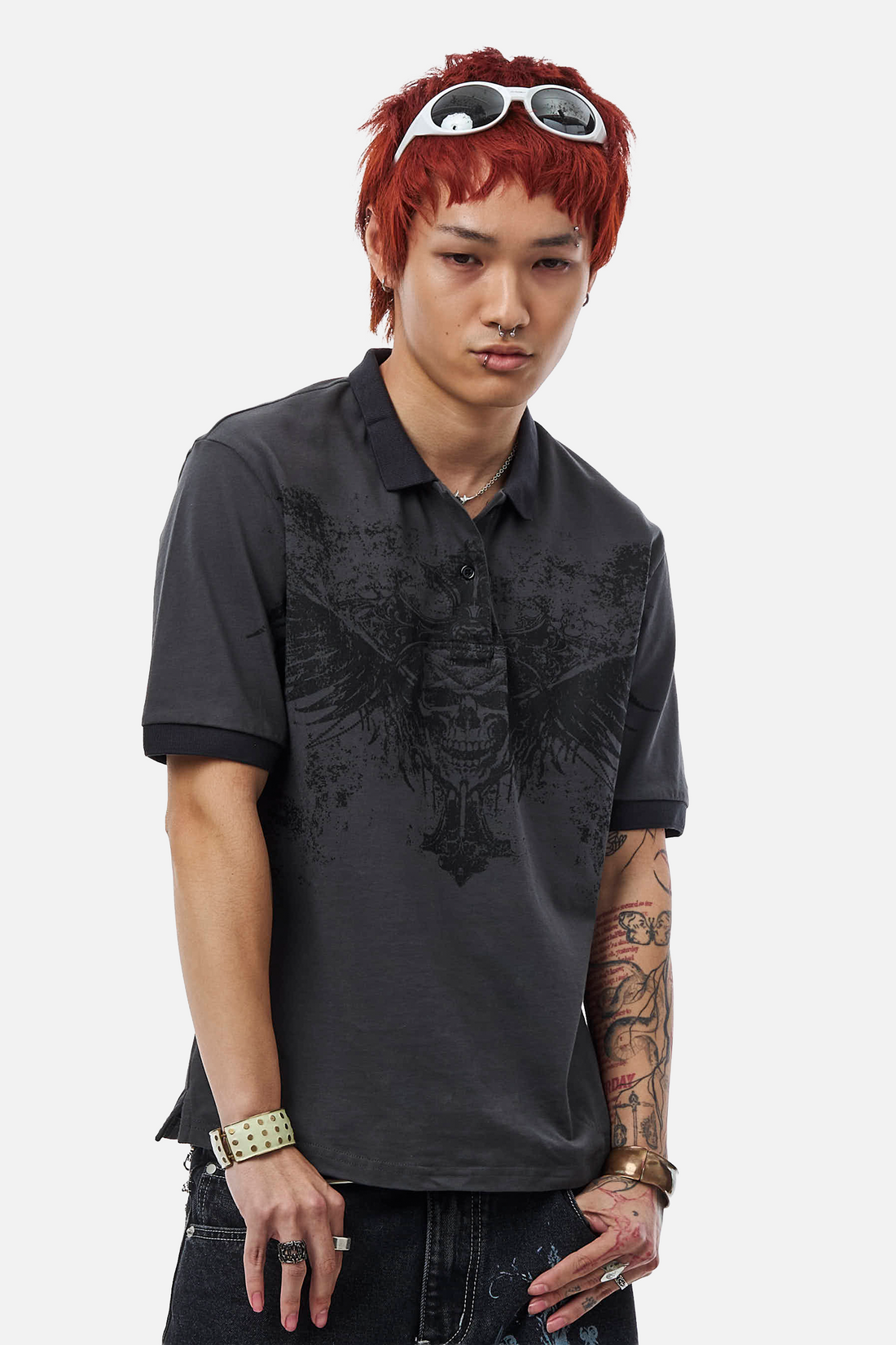Model in the Banished Polo, three-quarter view showing the winged skull print and black trim