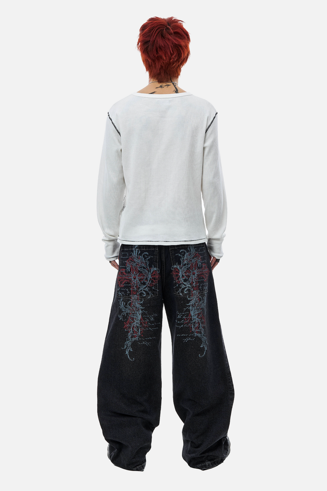 Full-length back view of a model in the Blessed Outlaw Denim with a white long sleeve