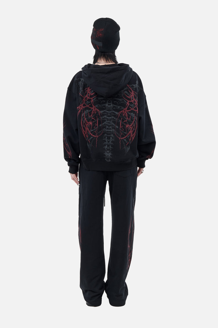 Back view of the Skeleton Sweatpants with matching ribcage print hoodie, full-length