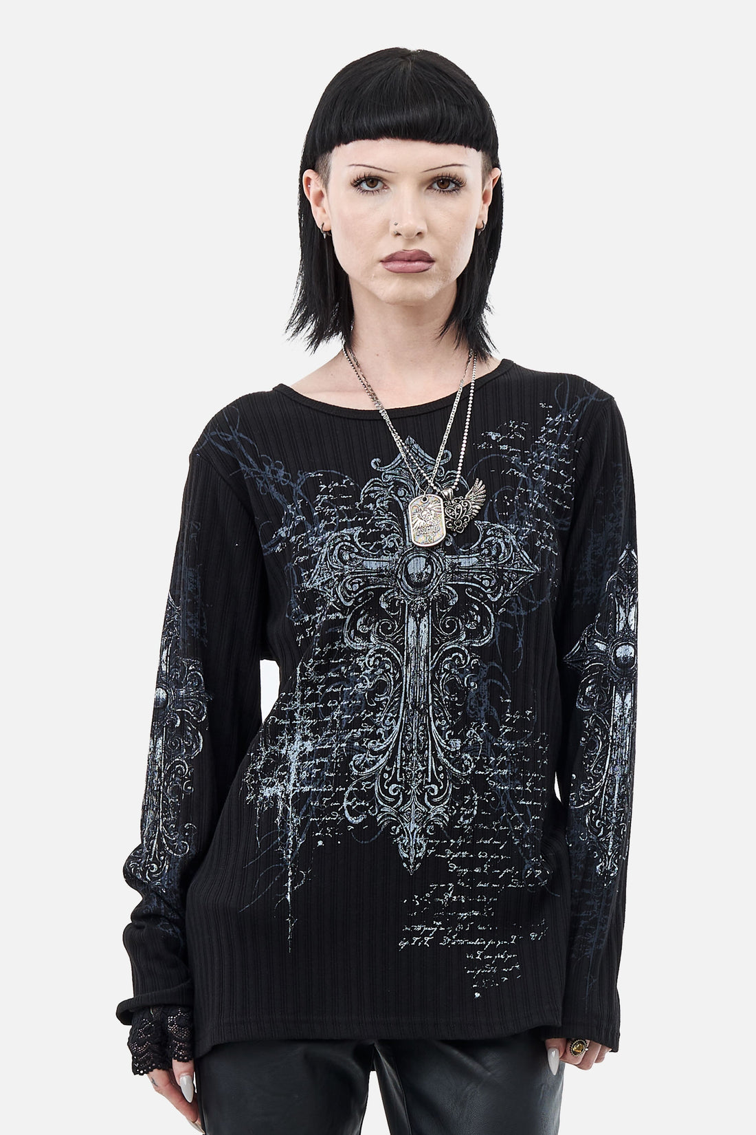 Model with a black bob wearing the Scripture Ribbed Long Sleeve with chain necklaces