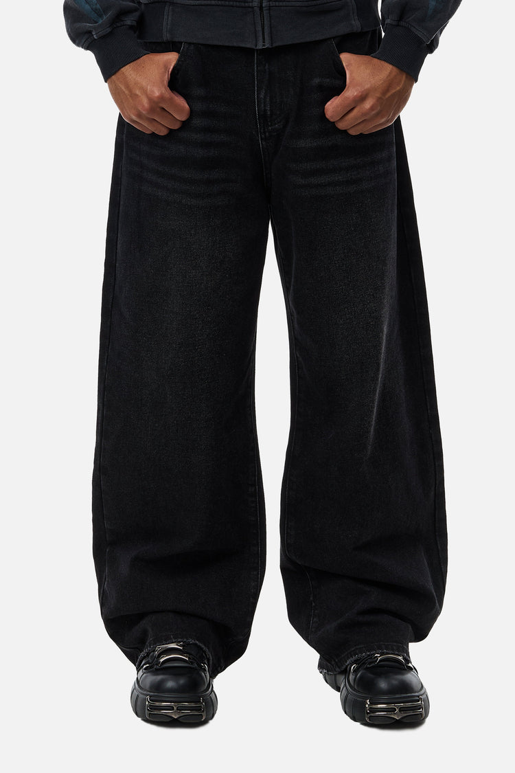 Front view of the wide-leg Blade Denim in washed black, styled with black chunky shoes